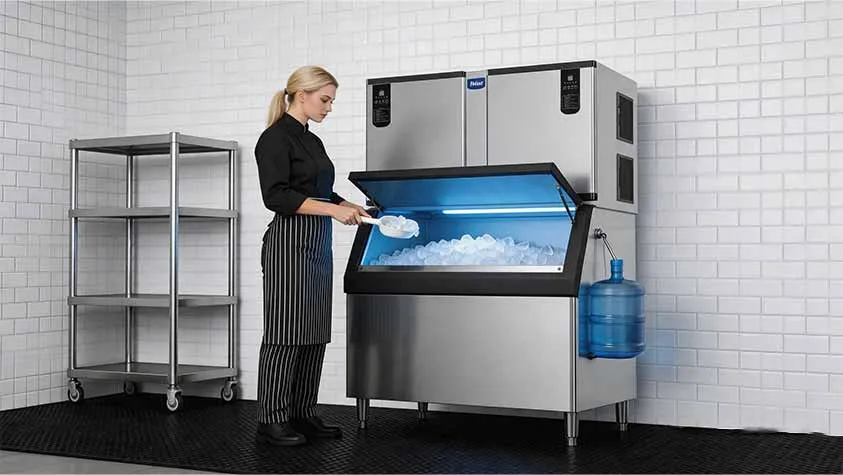 Restaurant kitchen staff scooping cube ice from Naixer commercial ice machine